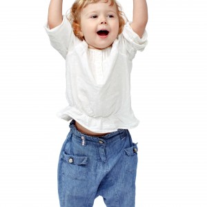 The child dances on a white background, indulge in, runs, plays, hands up